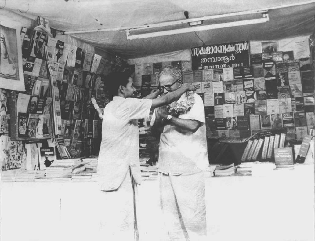 Founder K.R. Sukumaran Nair garlanding E.M.S. Namboodiripad inside the original Sukumar Book Stall at Thampanoor
